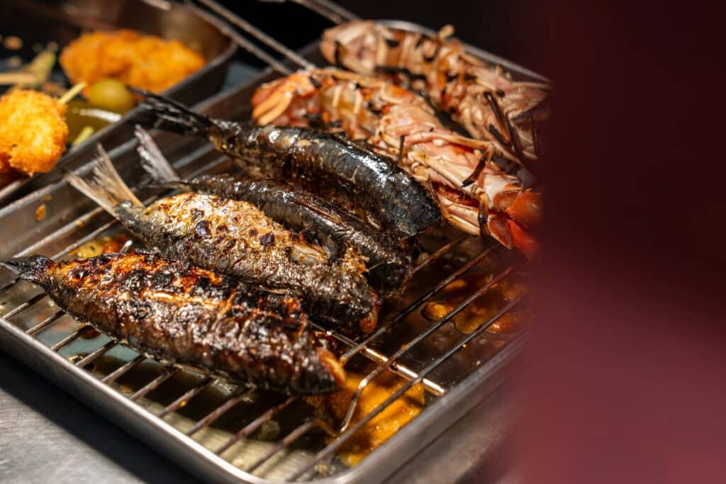 Fish and langoustine on the grill, chargrilled and almost ready for service