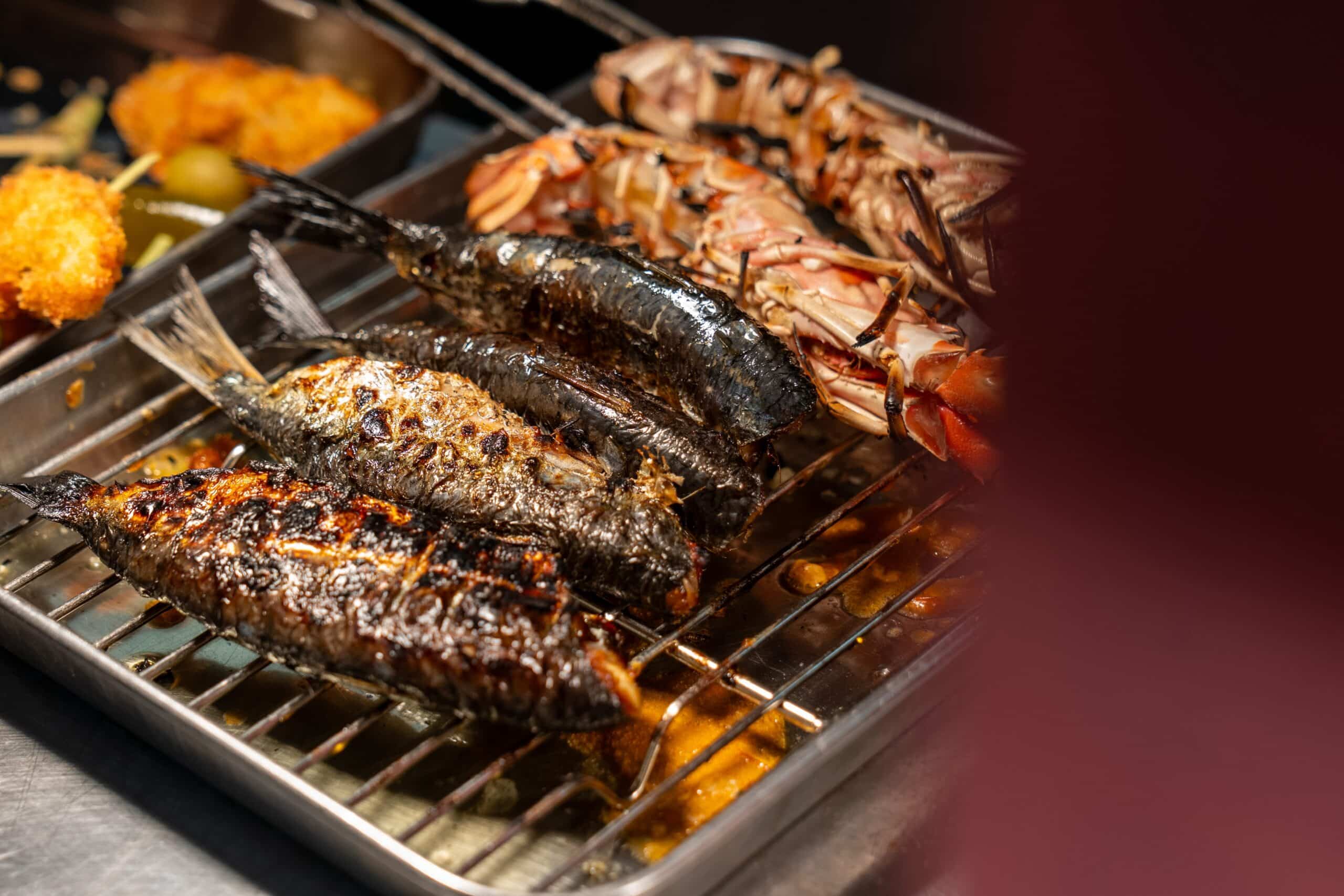 Fish and langoustine on the grill, chargrilled and almost ready for service