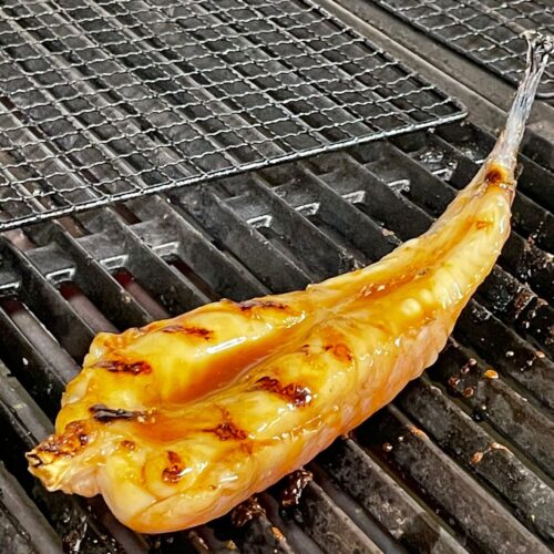 Monkfish tail being BBQ on the grill at Faber