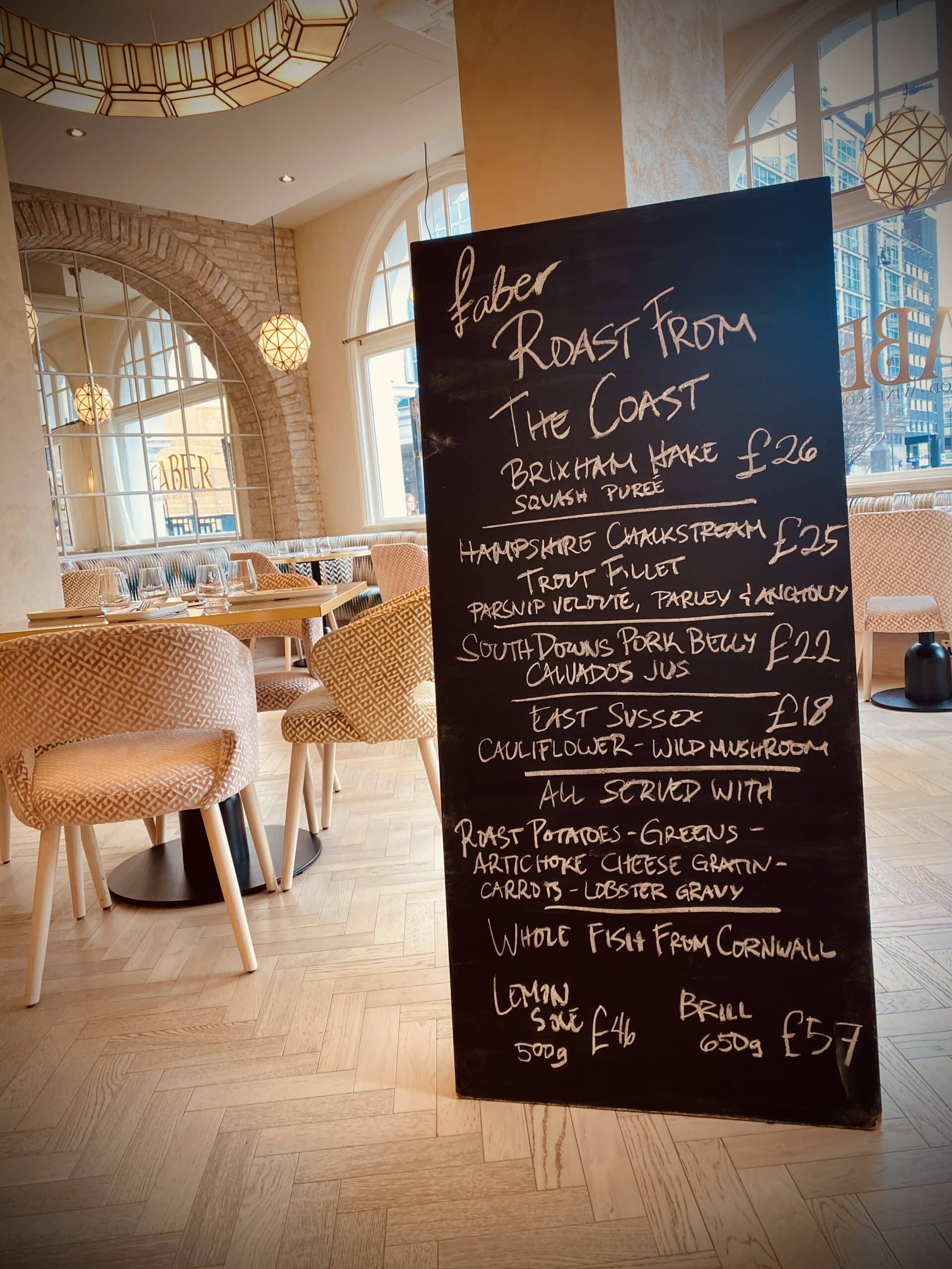 Daily chalkboard for our Sunday roasts, large chalkboard handwritten propped against the wall in Faber