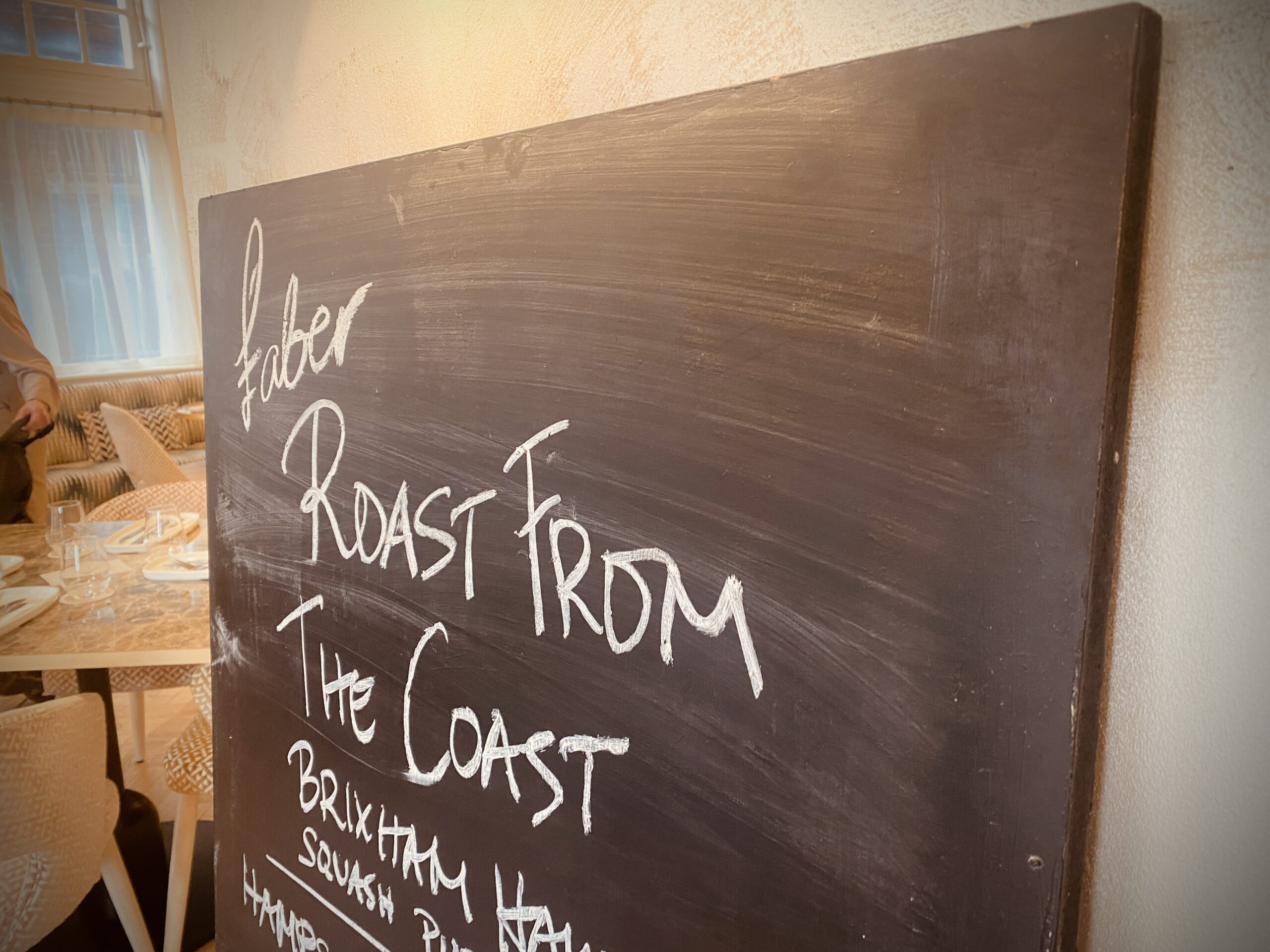 Chalkboard hand written with Roast form the coast written in clear handwriting