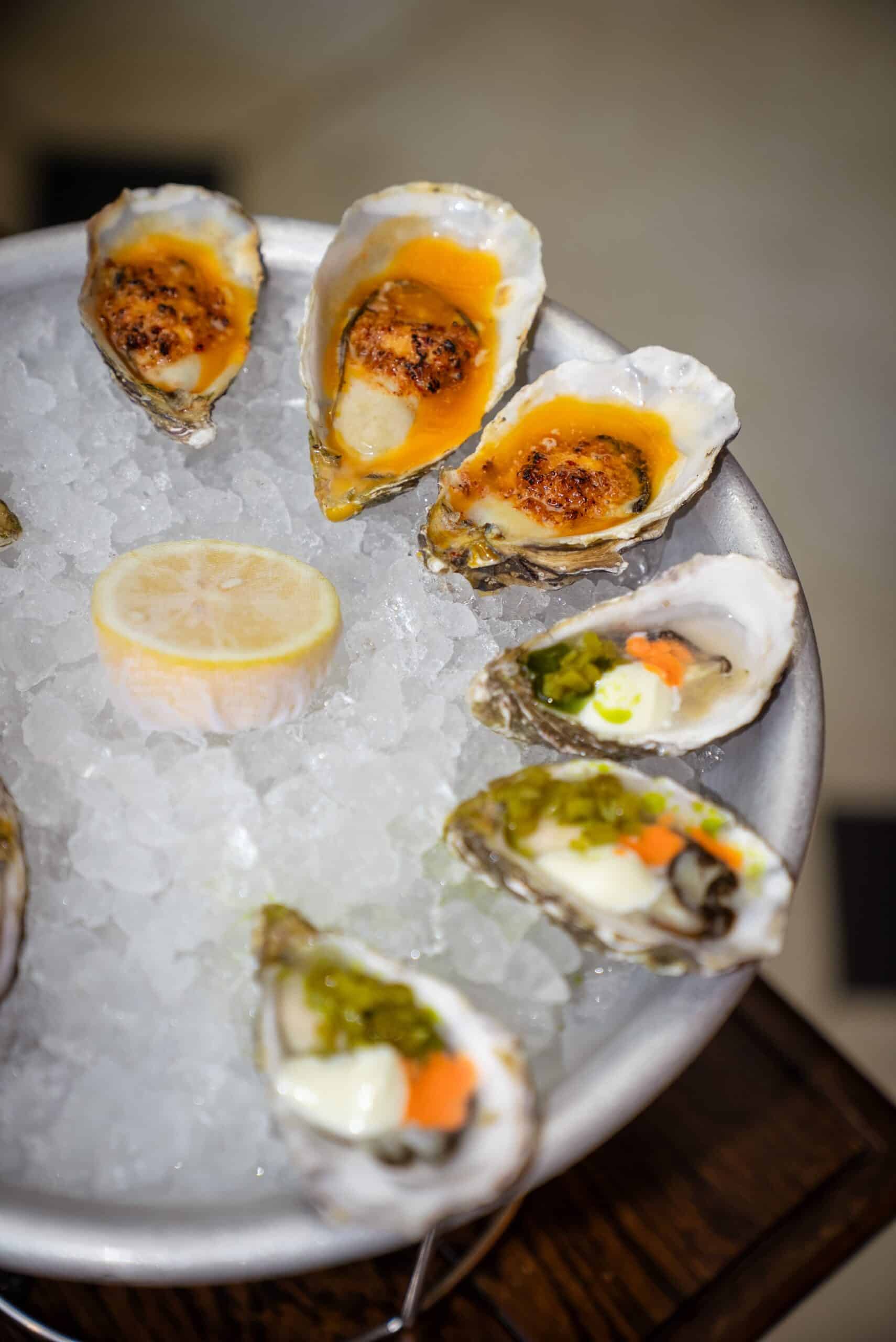 Oysters torched and dressed on ice with lemon at Holborn Dining Room